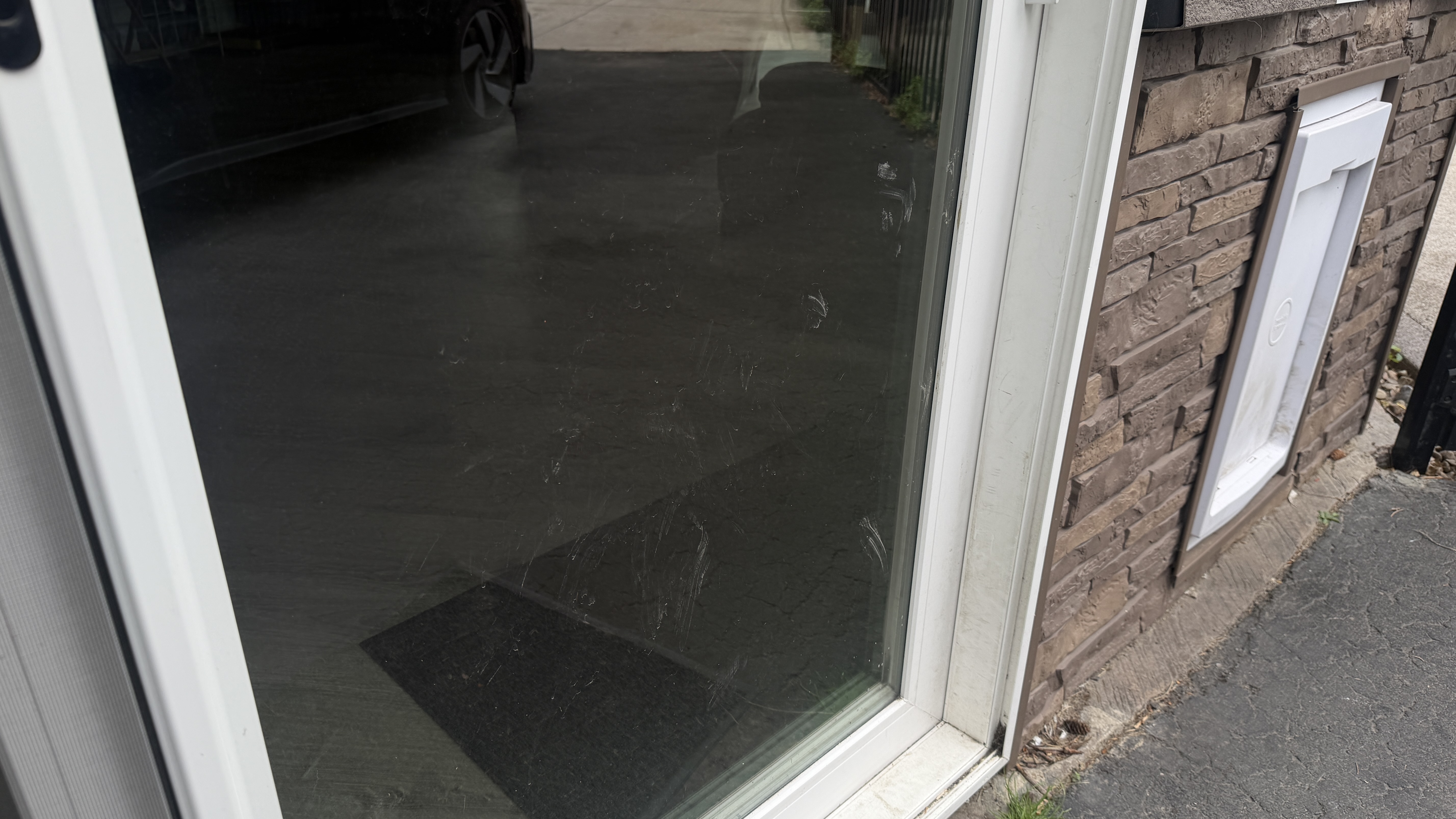 Before cleaning: patio door glass with visible smudges and marks